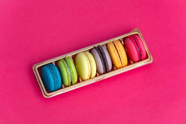 istock Colorful french macaroons on pink background 1480439939