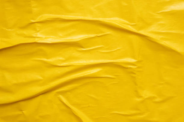istock Blank yellow crumpled and creased paper poster texture background 1480441003