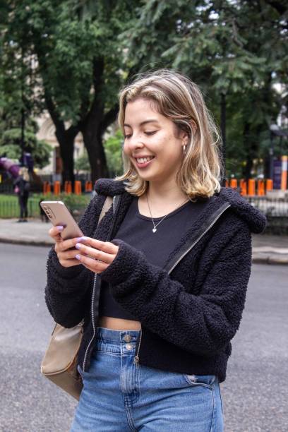 istock Young woman using mobile phone at city 1480445395
