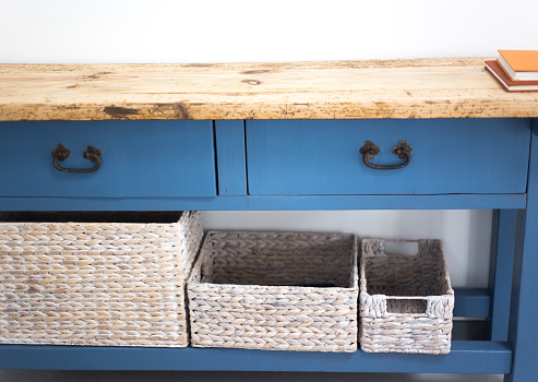 Home Decor with Blue Drawers and White Wicker Baskets