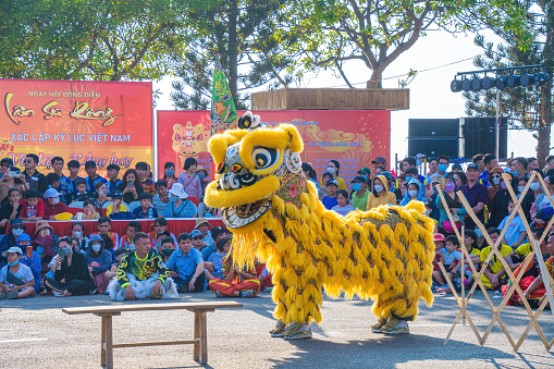 Vung Tau, VIETNAM - JAN 1 2023: Lion and dragon dance perform celebration new year. Group of people perform a traditional lion dance and dragon dance.