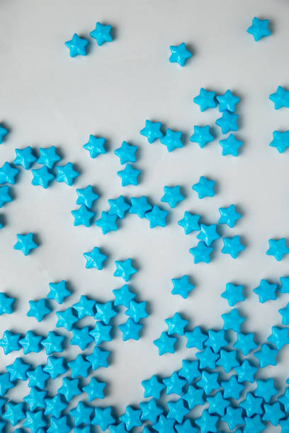 istock Blue star sugar sprinkles scattered on white 1480453937