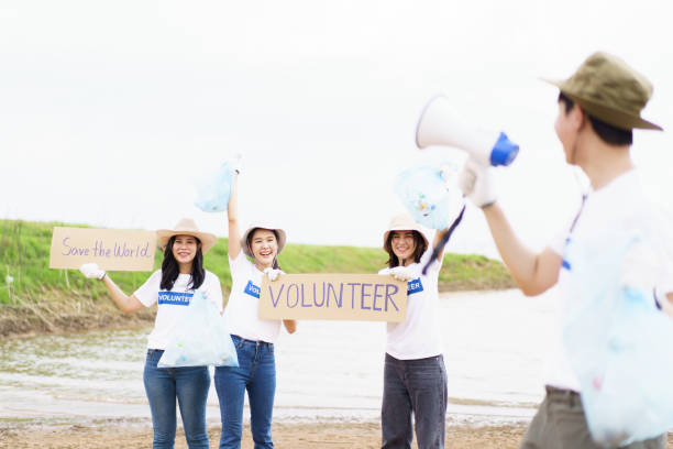 istock Group of volunteer collecting a garbage. 1480454744