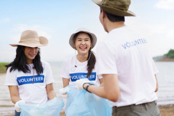 istock Group of volunteer collecting a garbage. 1480454805