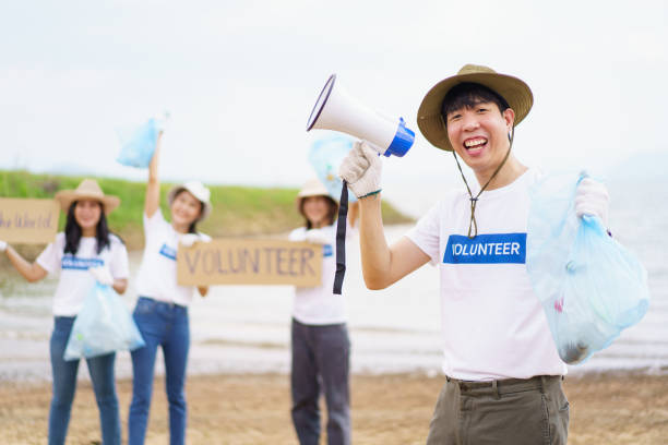 istock Group of volunteer collecting a garbage. 1480454971