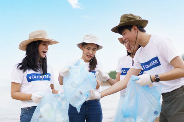 istock Group of volunteer collecting a garbage. 1480454985