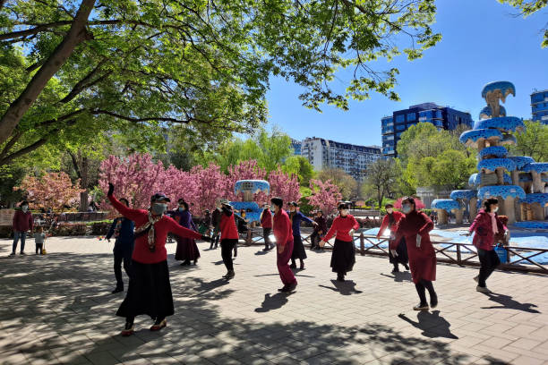 Beijing, China - April 7, 2023- Retired people dance as a sparetime hobby in park in Spring.