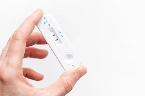 istock Hand holding a positive result for COVID-19 1480472128