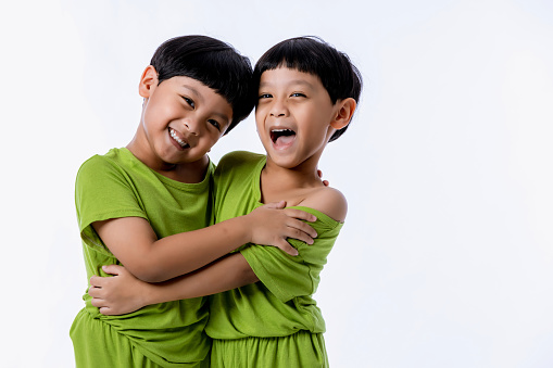 Portrait of cute Asian twins boys. two little boys twins isolated on white background. twins boys fun together on white background