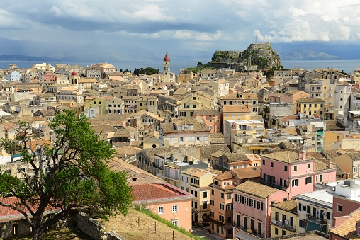 Italian flag closeup with Bastia cityscape in the background. Corsica island, France.