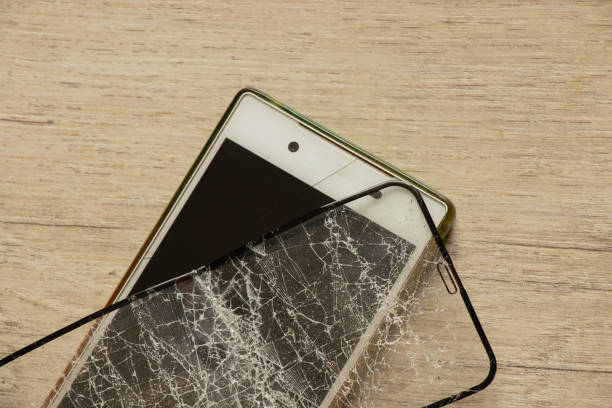 istock touch mobile phone and broken tempered glass on an isolated background, glass replacement 1480482151