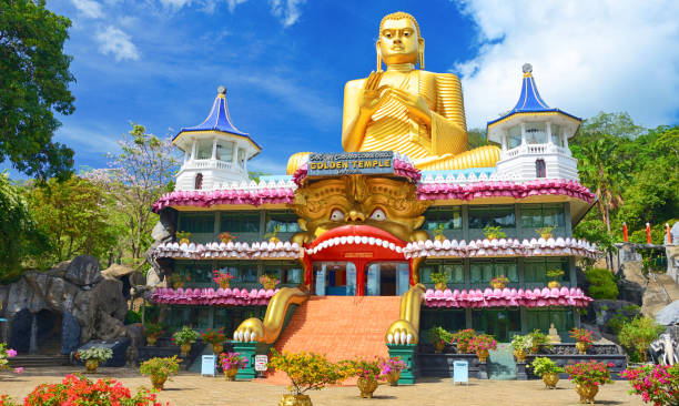The Golden Temple Dambulla New Buddhist museum within the Golden Temple. Giant gold Buddha built in 2001 sitting on the roof of the Golden Temple is one of largest in the world. This complex is one of the most popular attraction in Sri Lanka dambulla stock pictures, royalty-free photos & images