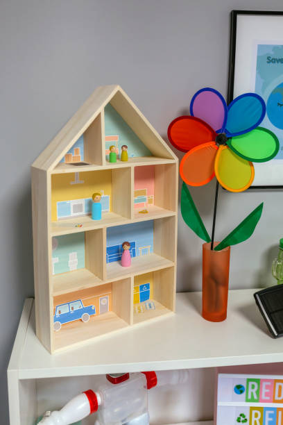 istock Sustainable house model and pinwheel over shelf in classroom 1480491724