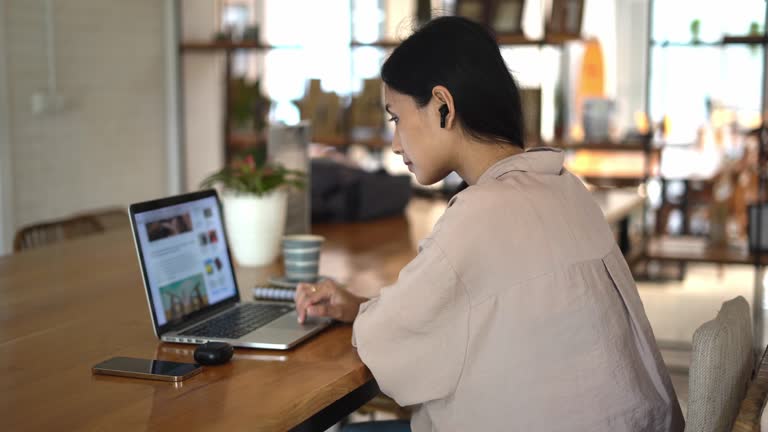 Asian female student study computer cafe. Woman read news. Girl internet learn.