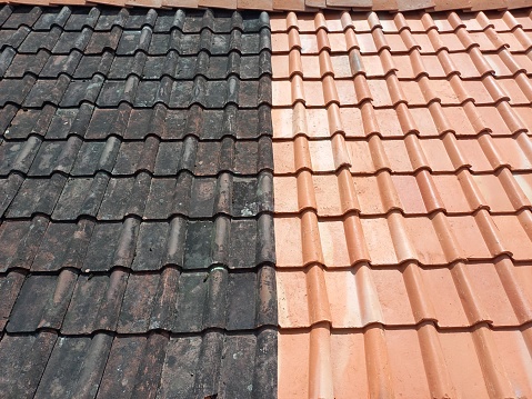 new and old tiles line the roof of the house