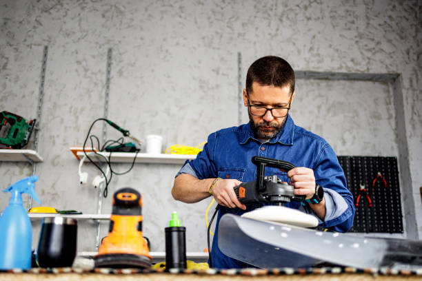 istock Repairman polishing plexiglass in workshop 1480493905