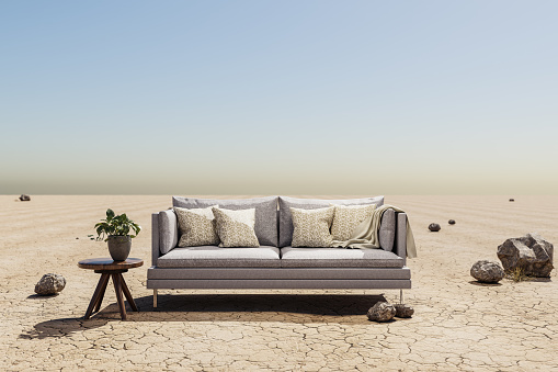 lonely living room couch in desert environment; immersion entertainment movie concept; 3D illustration