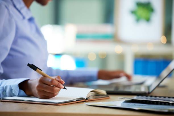 istock Hands, writing or notebook for company budget, financial data or insurance accounting in business office. Zoom, black woman or calculating finance worker and notes, tax schedule or fintech technology 1480495522