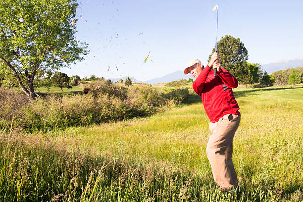 Amateur golfer hitting ball during summer day and the ball is coming towards the camera lens