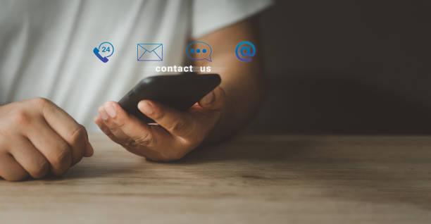 istock CONTACT US with icons. Man using phone support hotline people connect customer service. 1480498972
