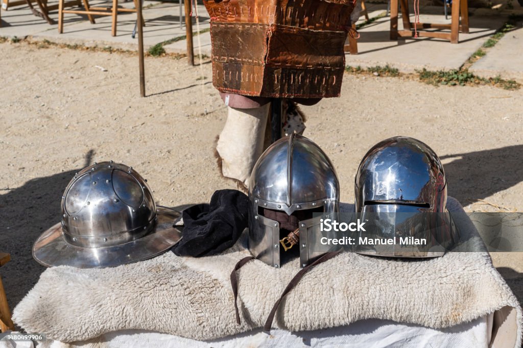Full armour, helmet and traditional clothing to recreate the Middle Ages at an open-air festival Adult Stock Photo