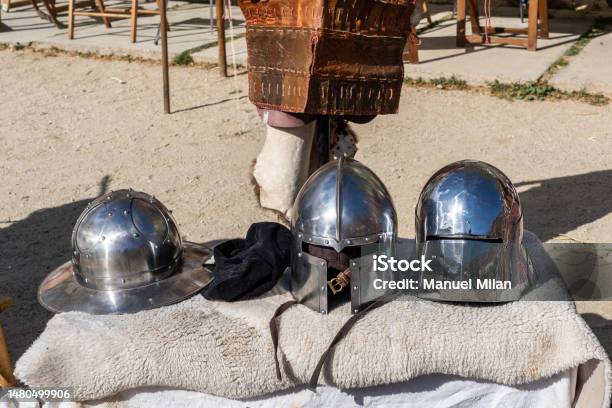 Full Armour Helmet And Traditional Clothing To Recreate The Middle Ages At An Openair Festival Stock Photo - Download Image Now