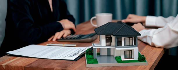 istock Reviewing house loan contract with agent using calculator. Enthusiastic 1480500165