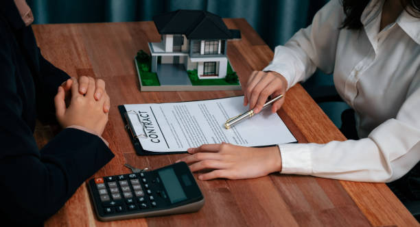istock Reviewing house loan contract with agent using calculator. Enthusiastic 1480500401