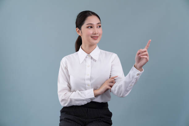 istock Asian operator wearing formal suit and headset with pointing finger Enthusiastic 1480501235