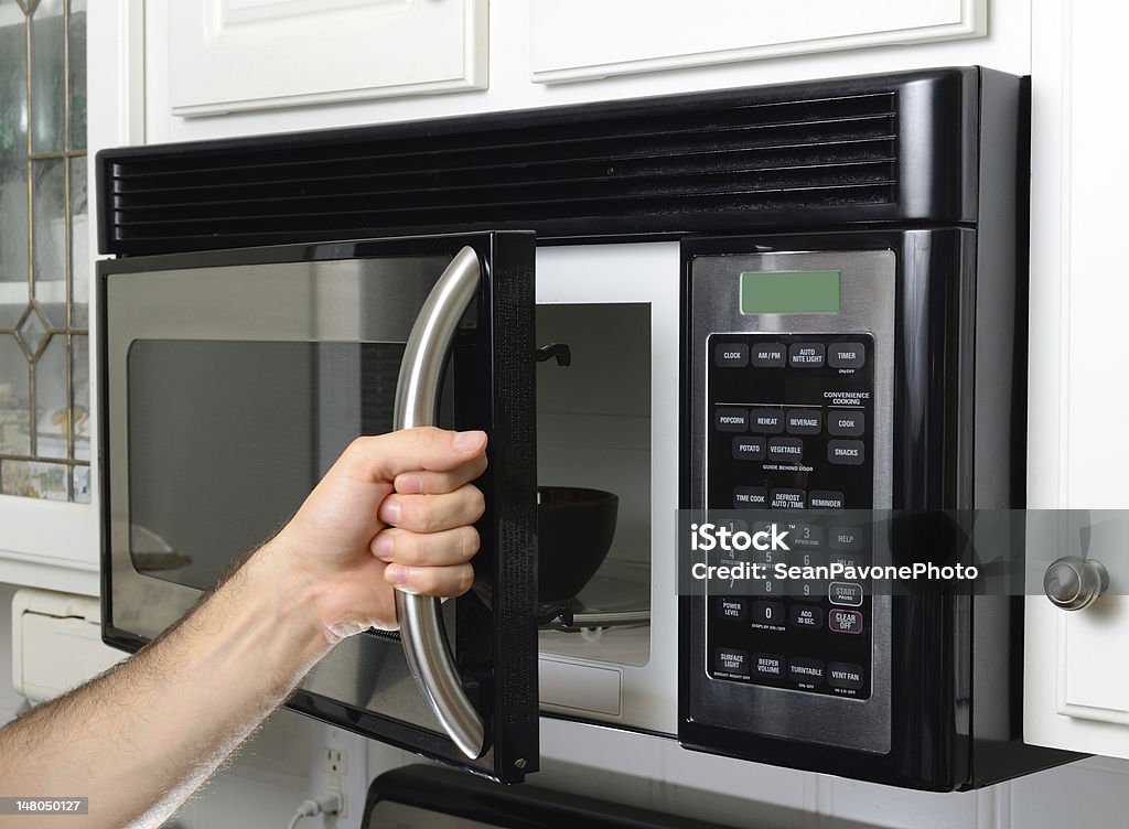 Hand Opening Microwave opening a microwave door Microwave Stock Photo