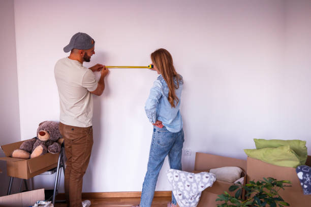 istock Couple using tape measure in their new apartment 1480501508