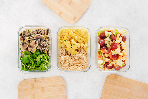 Glass lunch boxes, bamboo lid. Preparing meals for the week. Starter, main course and dessert. Balanced meal. Healthy food. Zero waste. Trendy meal. Concept. Batch cooking for the week.