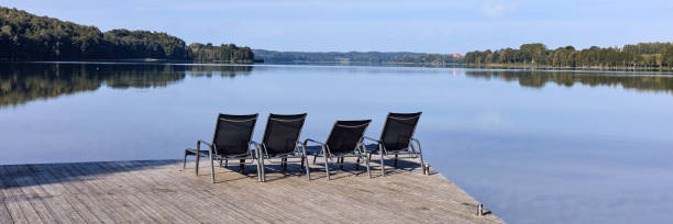 istock Empty pier with loungers on a quiet lake 1480505805