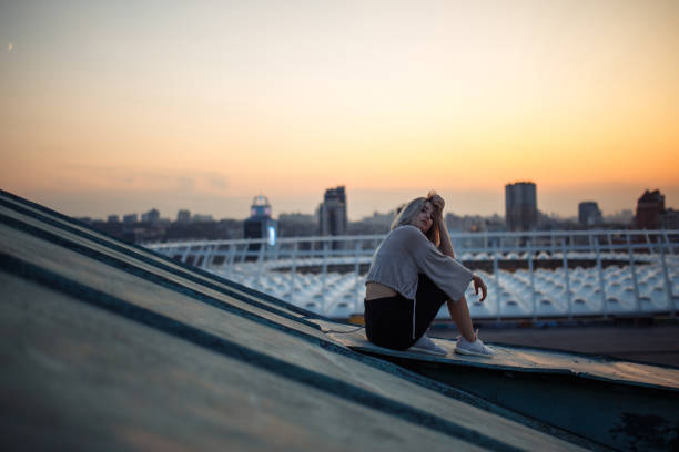 istock Beautiful woman on the rooftop posing at sunset. 1480509174
