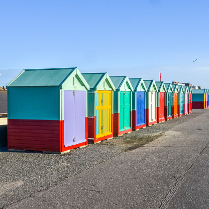 Row of beach huts on sea front in Worthing, Sussex, England