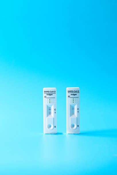 istock Two Covid-19 Test rapid antigen diagnostic test device with negative and positive result on blue background 1480511142