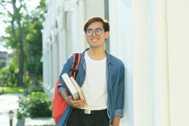 istock Student standing outdoor and holding books. 1480511937