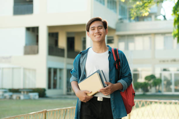 istock Student standing outdoor and holding books. 1480511947
