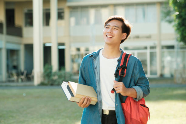 istock Student standing outdoor and holding books. 1480511969