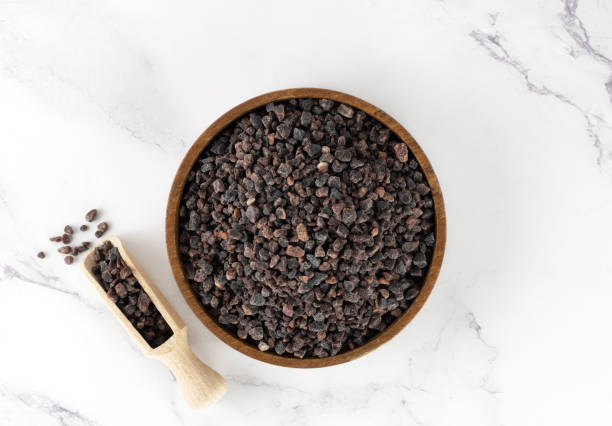 istock Himalayan crystal black salt in a gray bowl on a white background. Spices background. 1480521368