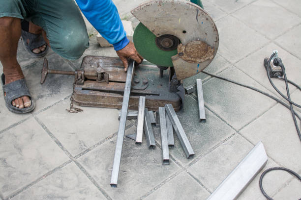istock worker cuts a metal pipe with some electric device or appliance 1480522071