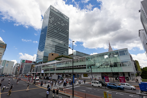 Tokyo, Japan - September 6, 2022 : Pedestrians walk past the JR Shinjuku Miraina Tower, NEWoMan shopping mall, Shinjuku Station and Shinjuku Expressway Bus Terminal‎ in Tokyo, Japan.