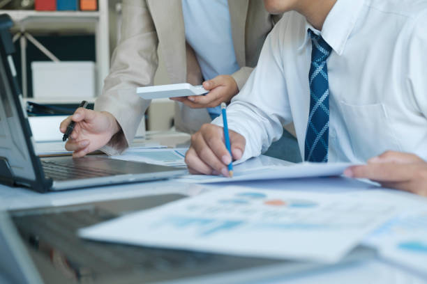 istock Businesspeople are working by discuss and analyses their project by using laptop and calculator. 1480533387
