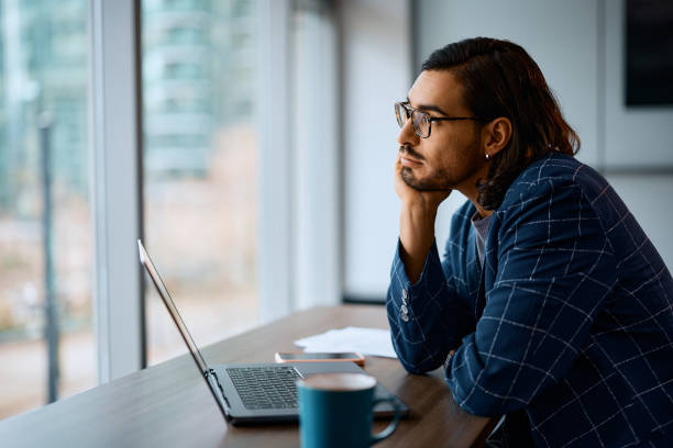 istock Pensive businessman working on laptop in the office. 1480538571