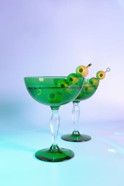 ジンとオリーブ:ゴージャスなグリーンアールデコグラスの2つのマティーニ - martini martini glass dirty martini olive ストックフォトと画像