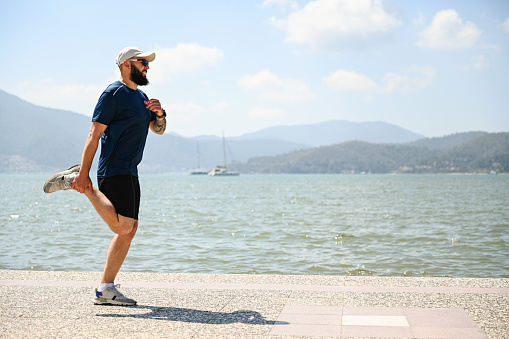 man walking and doing sports on the embankment