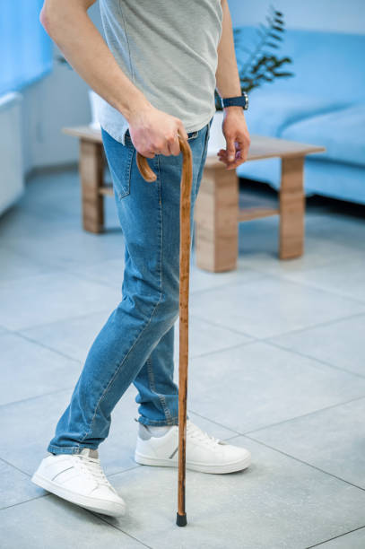 istock Close up of a man walking with a stick 1480545029
