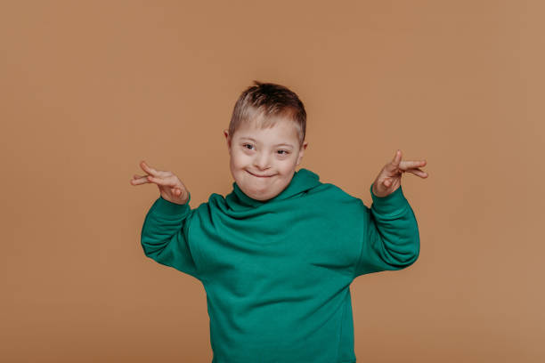 istock Portrait of little boy with down syndrome, studio shoot. 1480545154