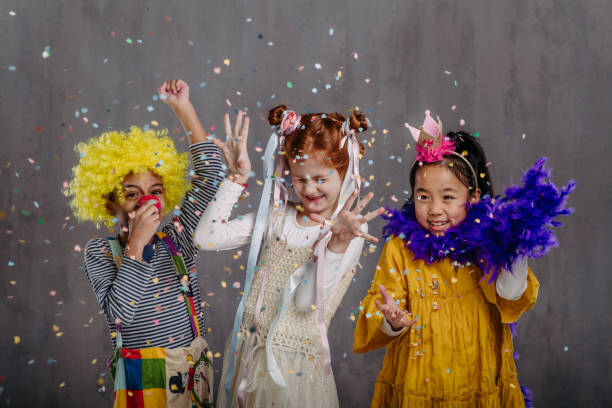 Portrait of three children in funny costumes, studio shoot. stock photo