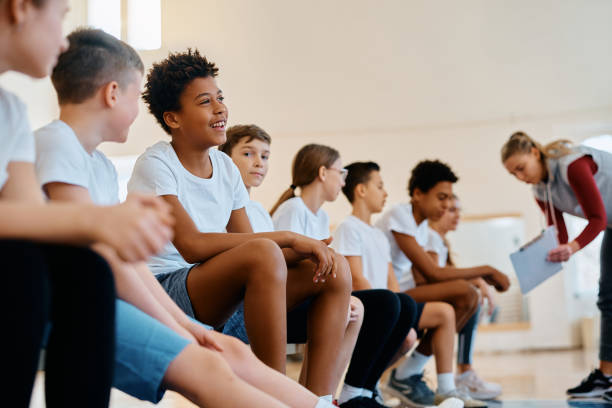 istock Happy black boy and his classmates during PE class at school gym. 1480545863